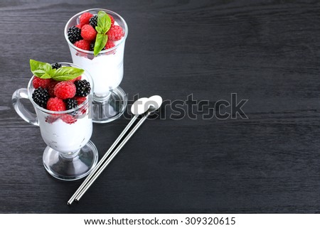 dessert of raspberries and blackberries on a black background