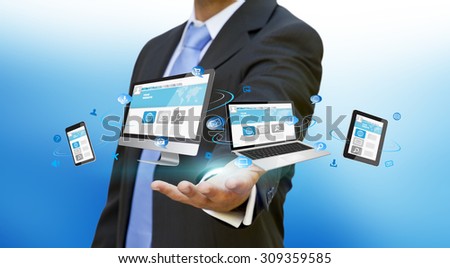 Businessman with computer phone and tablet in his hand