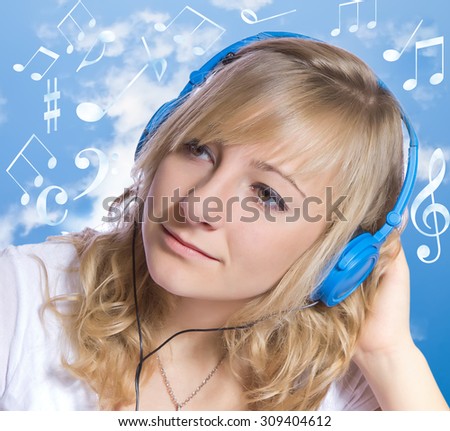 Attractive young woman listening to music on headphones.