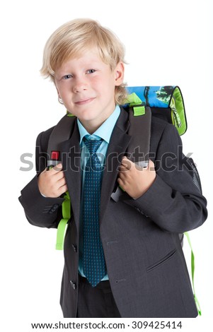 Schoolboy holding straps of schoolbag, looking at camera portrait, isolated on white background
