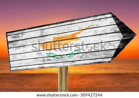Cyprus Flag wooden sign on beach background