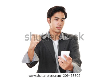 Happy Asian man holding a smart phone 	
