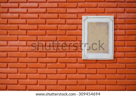 Old wooden frame on the grunge brick wall