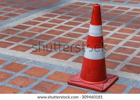 Orange traffic cone on the floor background