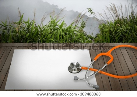 stethoscope and peer on wood background.