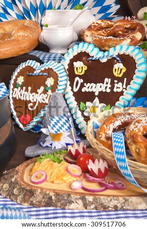 All typical German Bavarian symbols in one picture. Gingerbread heart with â??The beer is tappedâ?? text, soft pretzels and Bavarian veal sausage