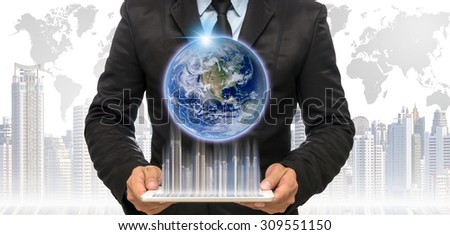 Businessman holding the tablet with earth and building on the cityscape and world map background,Elements of this image furnished by NASA