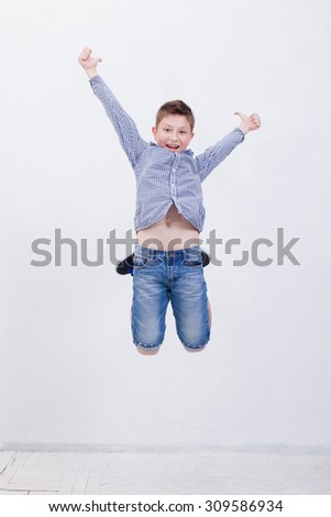  happy young boy jumping over a white background