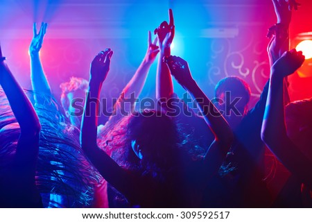 Energetic crowd partying all night long Royalty-Free Stock Photo #309592517