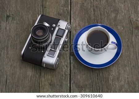 retro the camera and a cup of black coffee on a table