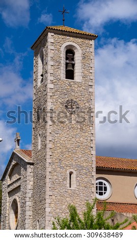 In the picture we can see the belfry with a blue sky with clouds