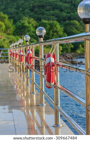 Rows of stainless fences  and Red lifebuoy