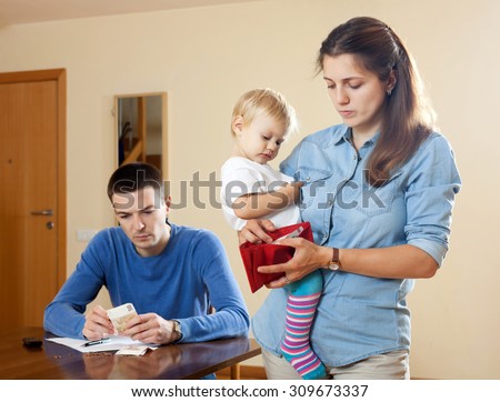 Financial problems have man and wife  with baby Royalty-Free Stock Photo #309673337