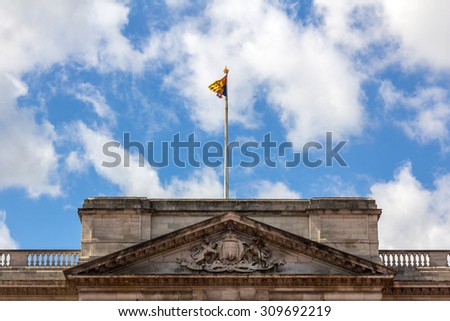 Royal Standard of the United Kingdom waving on the Buckingham Palace in London