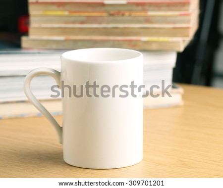 White Coffee cup on wooden table.