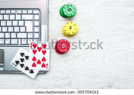 Laptop, poker cards and poker chips