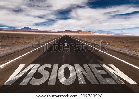 Vision (in German) written on desert road