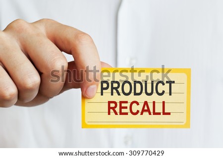 Product Recall. Man holding a card with a message text written on it