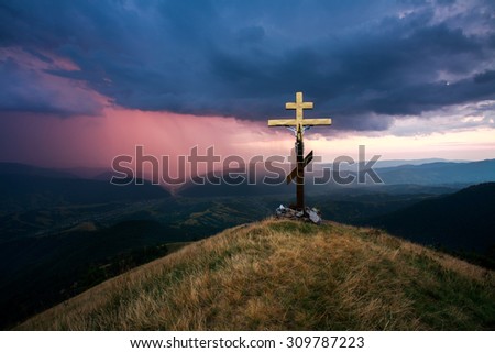 Cross over the valley on a background of dramatic sky with storm clouds