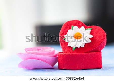 Red heart box wiht white flower.