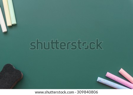 Chalkboard, blackboard with colored chalks and eraser for background.