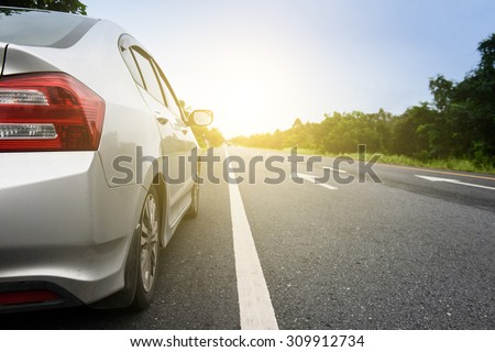 Close up side of  silver car and light on the  road Royalty-Free Stock Photo #309912734