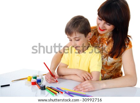 Little boy with crayons on a white background