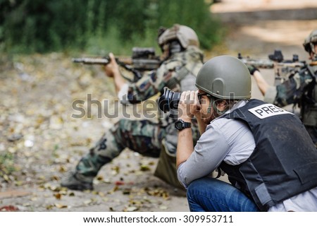 Photojournalist documenting war and conflict Royalty-Free Stock Photo #309953711