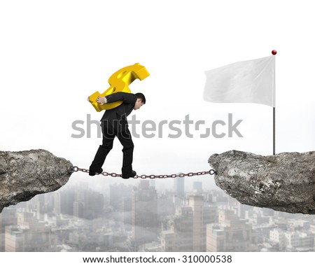Businessman carrying golden dollar sign balancing on rusty chain, walking to white flag on cliff, with city background.