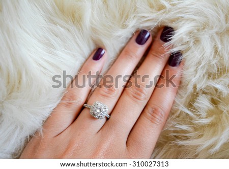 Diamond ring on a finger Royalty-Free Stock Photo #310027313
