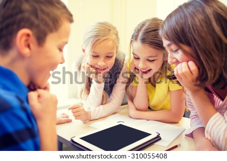 education, elementary school, learning, technology and people concept - group of school kids with tablet pc computer having fun on break in classroom Royalty-Free Stock Photo #310055408