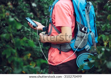Charging mobile phone during the journey Royalty-Free Stock Photo #310270499