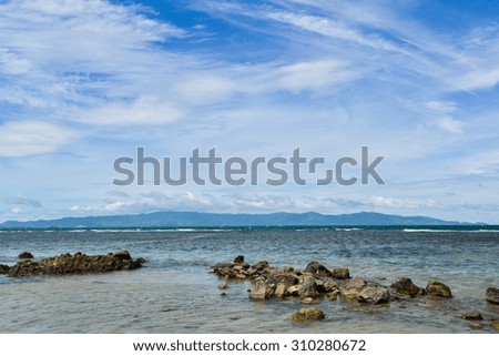 Clear blue sky with cloud and sea in a shiny day