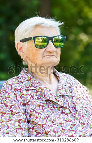 Picture of a funny senior woman wearing sunglasses