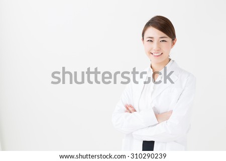 portrait of young asian doctor isolated on white background Royalty-Free Stock Photo #310290239