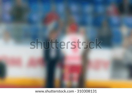Abstract blur of ice hockey players at tournament play. Bokeh background