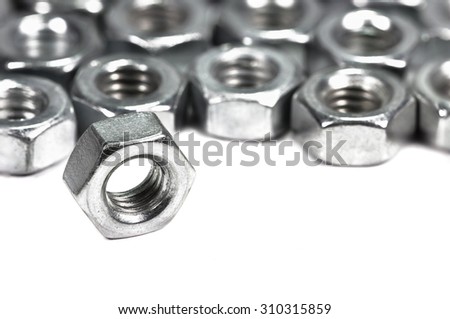 Closeup metal screw (bolt) and nuts on white background.