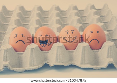 four brown eggs  with faces drawn 