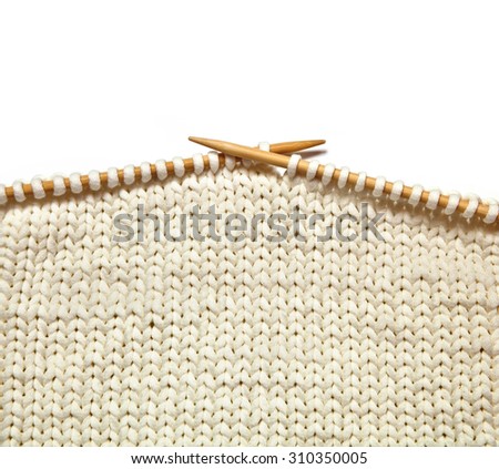Two bamboo knitting needles in process of knitting Royalty-Free Stock Photo #310350005