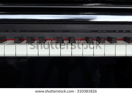 close-up of piano keys of black piano