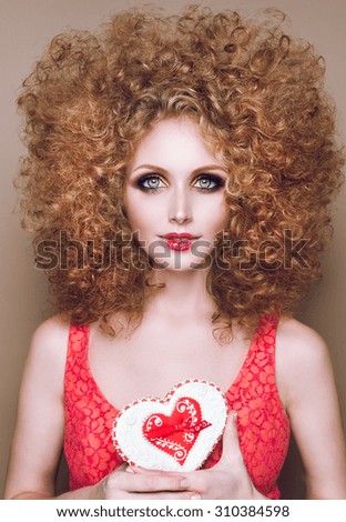 face of a beautiful young woman with red heart