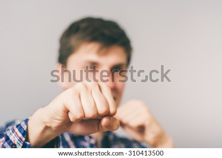 Businessman with his fists raised ready for a fight.