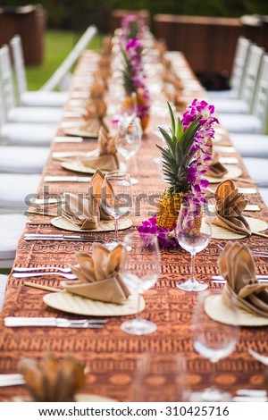Tables and chairs at an outdoor event in a tropical location