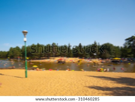 Blurred background, blurred photograph of people having vacation at lake in summertime