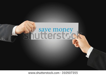 Close-up Of Two Businessman's Hand Holding Paper With Save Money Word On It