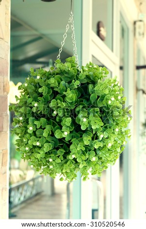 green plastic bouquet flowers hanging decoration in front of cafe