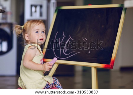 blonde little girl learning to draw