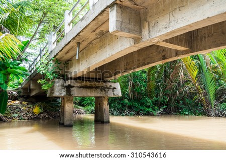 Simple concrete bridge over a canal in Ben Tre province in the Mekong Delta region of southern Vietnam.