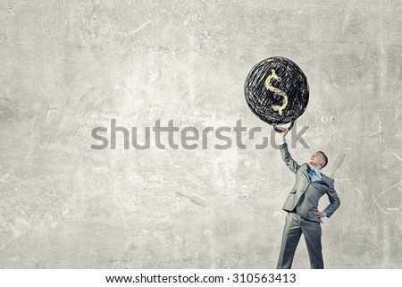 Young businessman lifts up heavy weight with dollar sign