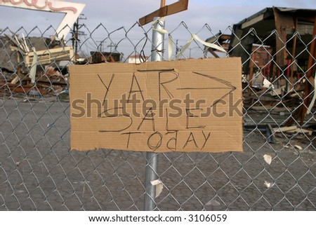 "YAR SALE TOdAY ->" sign on a fence